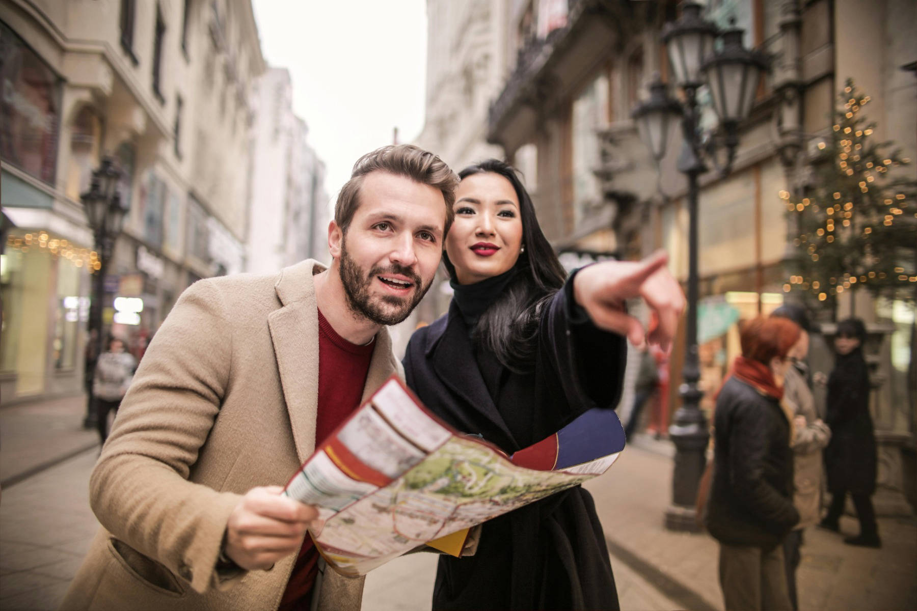 Man and a woman consulting a map. Woman pointing out 