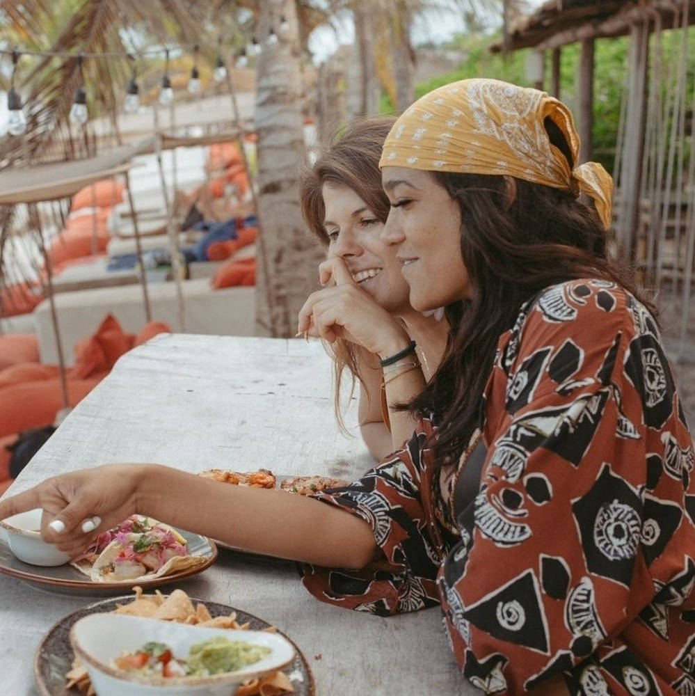 Friends eating lunch at a restaurant in Tulum