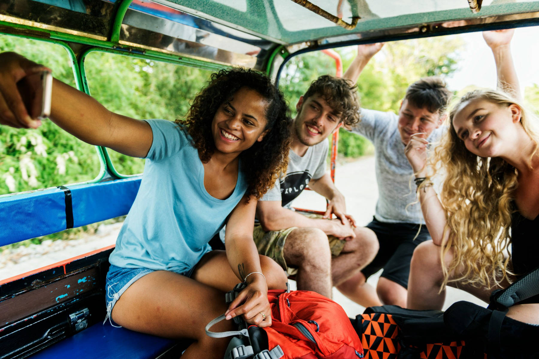Group of young people take a selfie in the back of a truck