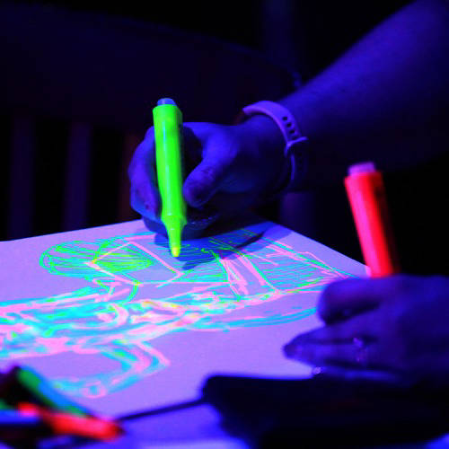 close up image of neon pens being used on a paper
