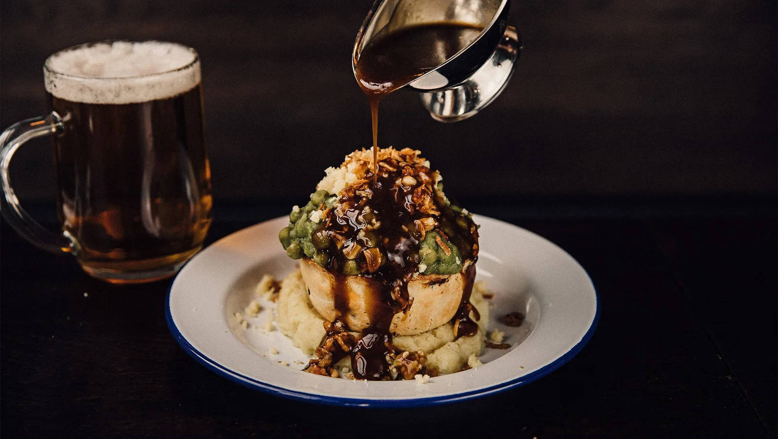 Pieminster pie being drenched in gravy