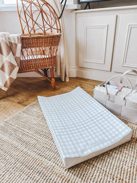 The little bumble co. anti roll changing mat in a nursery